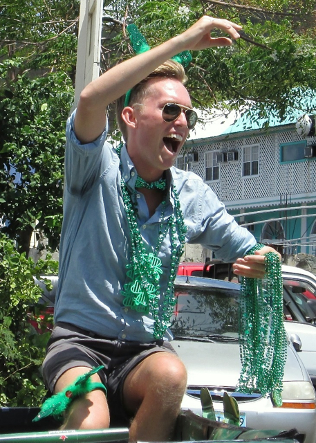 David Ward of St. John throws green beads to the crowd.