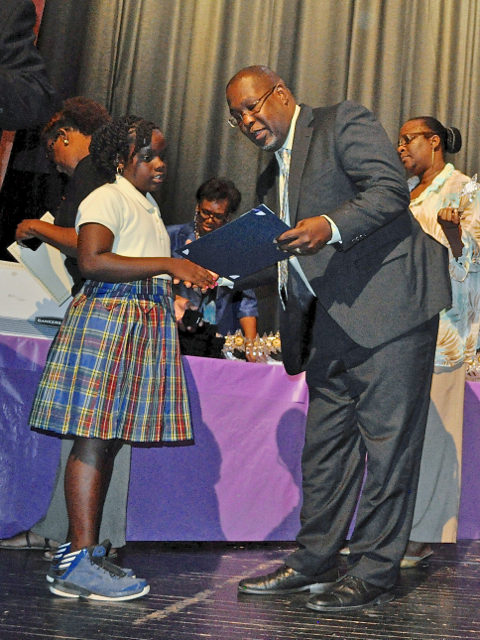 St. Croix Superintendent Gary Molloy presents a Shining Star awards to Kidejah Archibald at the High Achievers award ceremony Sunday.