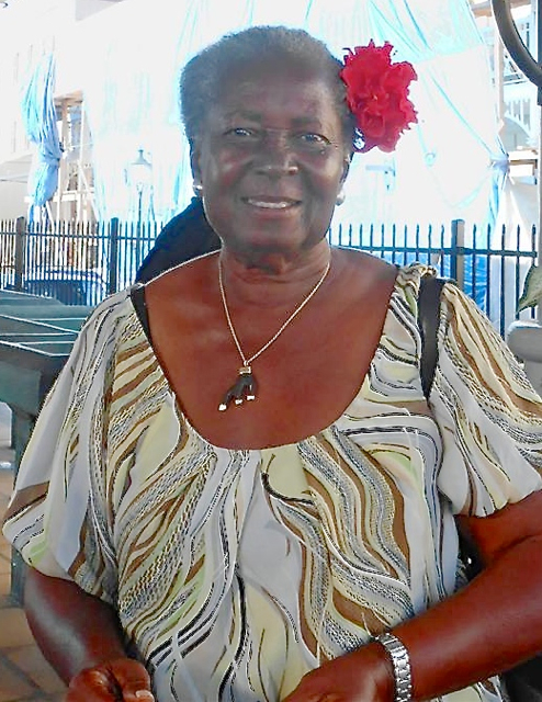 Market Square veteran Mary Moore wears an ant-free hibiscus in her hair.