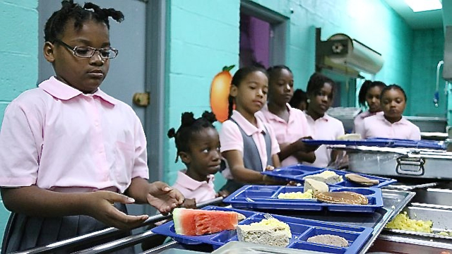 Students at Gladys Abraham Elementary School get a healthy breakfast, including fruit.
