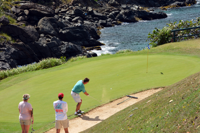 Louri Lynn Throgmorton and Andy Heath watch JP Montegut putt at the Captain Morgan Golf Scramble. (Dean Barnes photo)