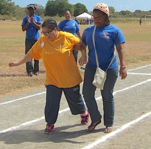 Christine Rhymer, with assistance, participates in one of the first events of the Special Olympics Saturday at Renaissance Park..