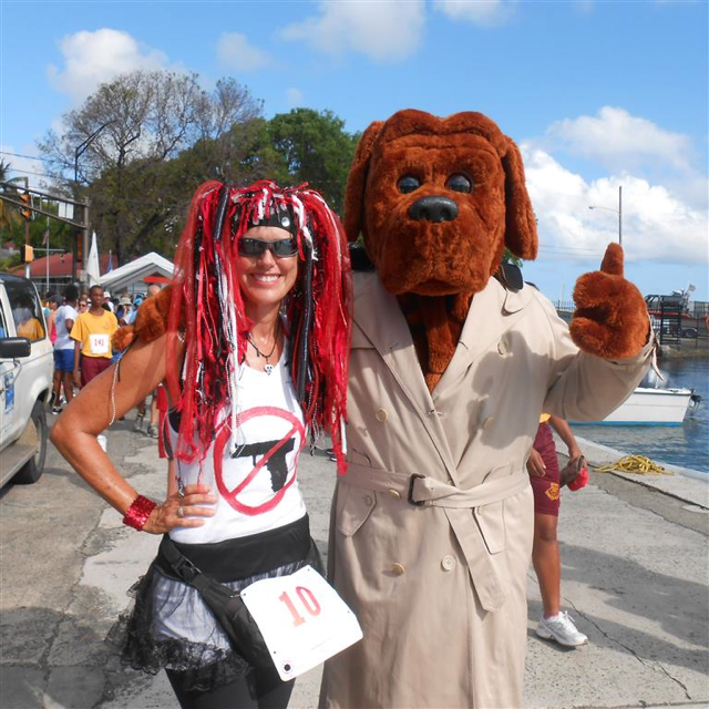 Brenda Silvia poses with McGruff the crime dog before the start of Sunday's race.