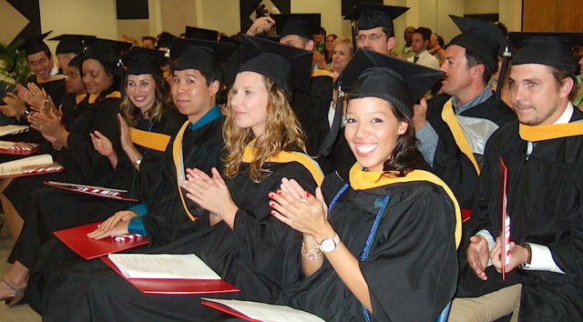 Graduates from the Barry University physician's assistant program on St. Croix respond to the keynote speaker's comments.