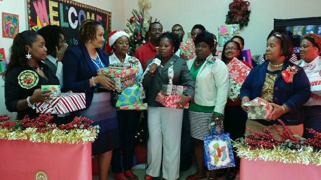 Vivian St. Juste, fifth from left, thanks interim Education Superintendent Dionne Wells, third from right, and the Education staff.