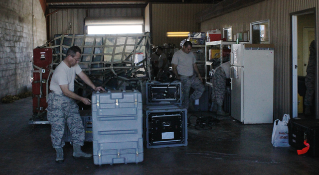 Members of the 53rd Weather Reconnaissance Squadron Hurricane Hunters prep their gear Saturday at the Henry E. Rohlsen Airport for their return to Mississippi.