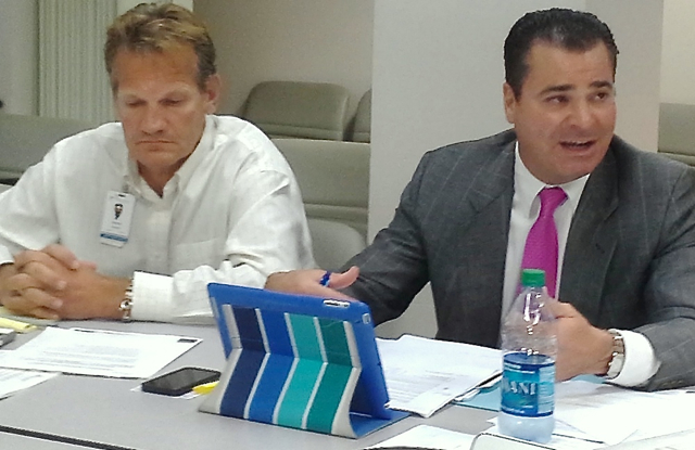 Michael Younger, left, interim chief financial officer of the Juan F. Luis Hospital, and Philip Arcidi, finance committee chairman, discuss the hospital's financial condition at Wednesday's board meeting.