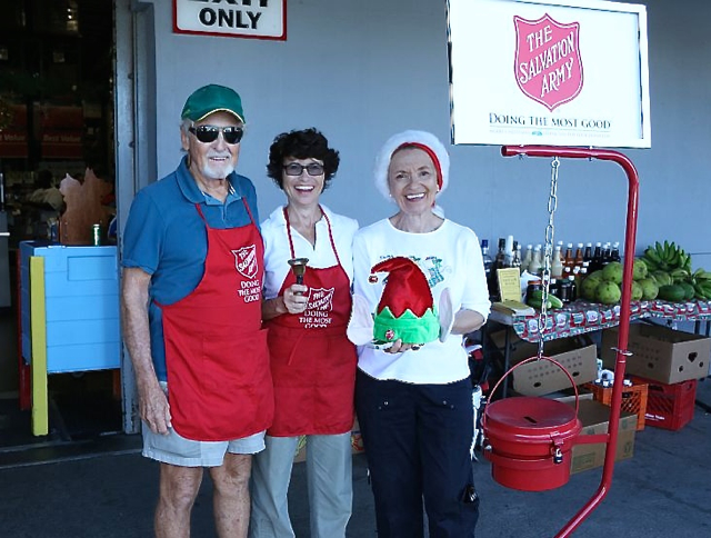 From left, St. Thomas Club of Rotary Sunrise members Richard Bryant, Susan Bryant and Claudia LaBorde ring the bell in front of Cost-U-Less.