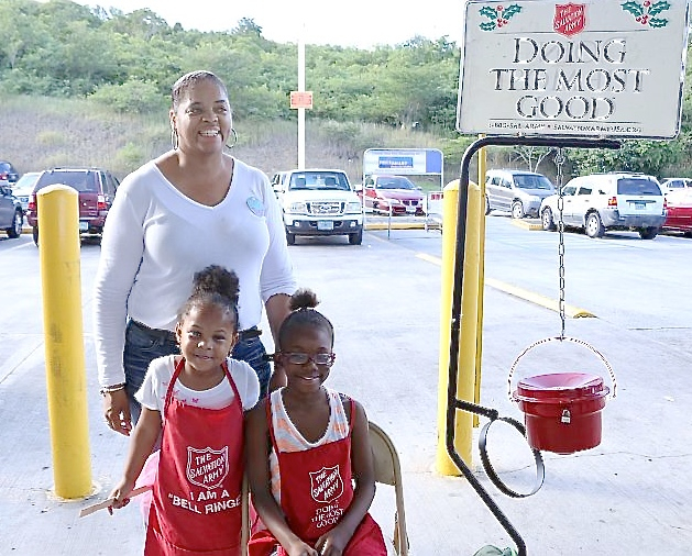 Rotarian Yvette Sutthin and Lockhart Elementary Early Act members Aliya Williams and Jayne Ashby work the kettle in front of PriceSmart.