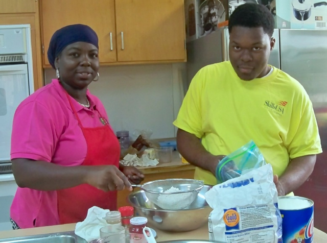 Romano THomas and his mother, Dawn-Marie Thomas, take part in a 2013 fruitcake workshop at UVI.
