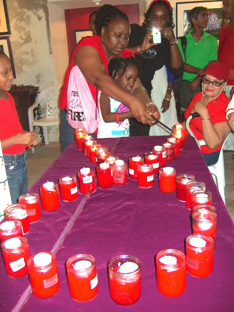 Participants line up to light candles for the World AIDS Day vigil Monday. 