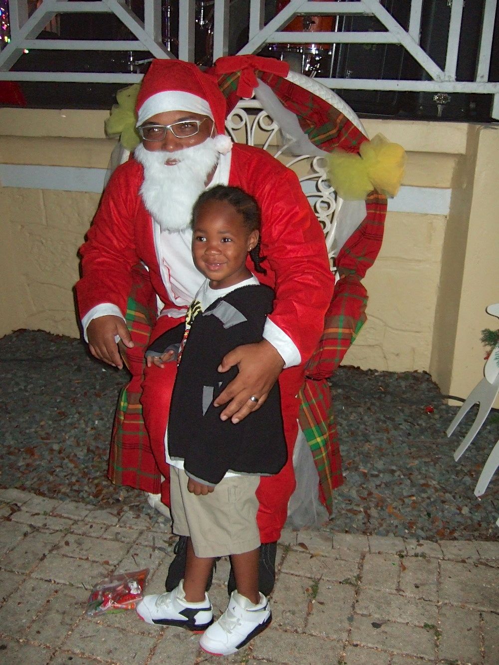 Santa Claus gets a beaming smile Saturday from a young fan in Buddhoe Park.