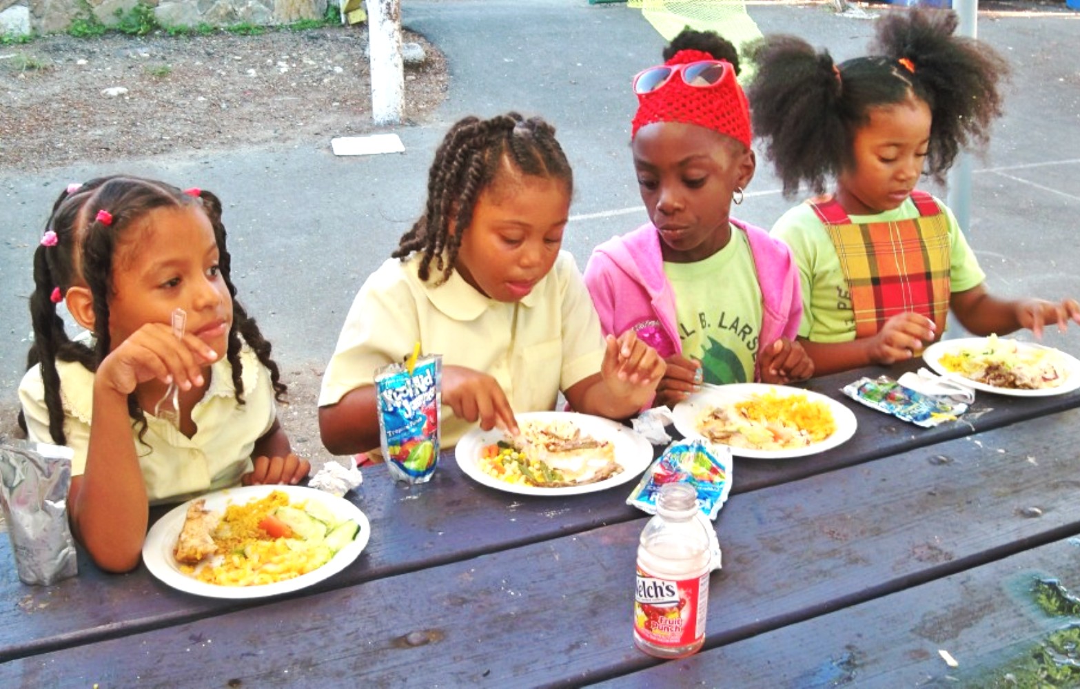 From left, Flambeiys Lyna, O'Keisha Williams, Jaelyn Bailey, and Grace Martin eat Thanksgiving dinner at the Boys and Girls Club (Carol Buchanan photos).