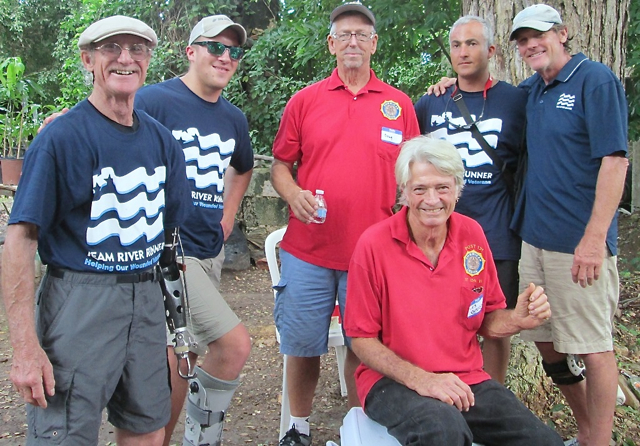 From left, Veteran Ron Rudy, veteran Kyle Pietzke, Doug Benton of the American Legion, Tomas Carrasquel, and Team River Runner Director Joe Mornini surround American Legion member Les Anderson, who is sitting on the ice chest.