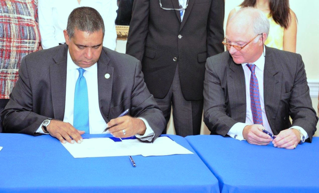 Gov. John deJongh Jr. and Stephen Evans-Freke, managing partner of Water Island Development Company, sign a lease agreement Wednesday morning that will facilitate the development of a boutique resort on Water Island. (Government House photo)