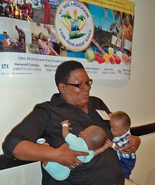 Donabel Pierre, from WIC, demonstrates how to breast feed twins.