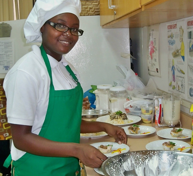 Chrystal George, 16, serves beef wonton cups for the World Food Day Youth Super Chef competition.