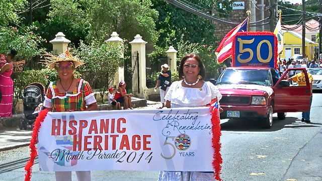 Friendship Committee members Mirza Saldania Lampe, left, and Domitila Vargas, lead the parade.