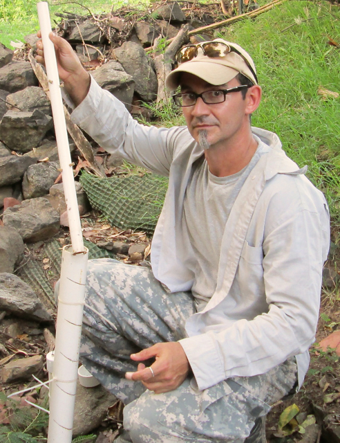 Carlos Ramos demonstrates one of his runoff gauges.