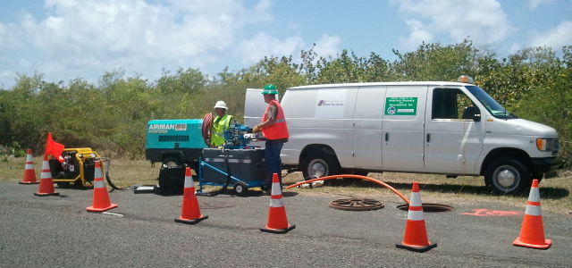 Workers for viNGN contractor All Rounder/Trans-Tel Central instal fiber optic cable in WAPA conduit along Melvin Evans Highway in St. Croix. (Government House photo)