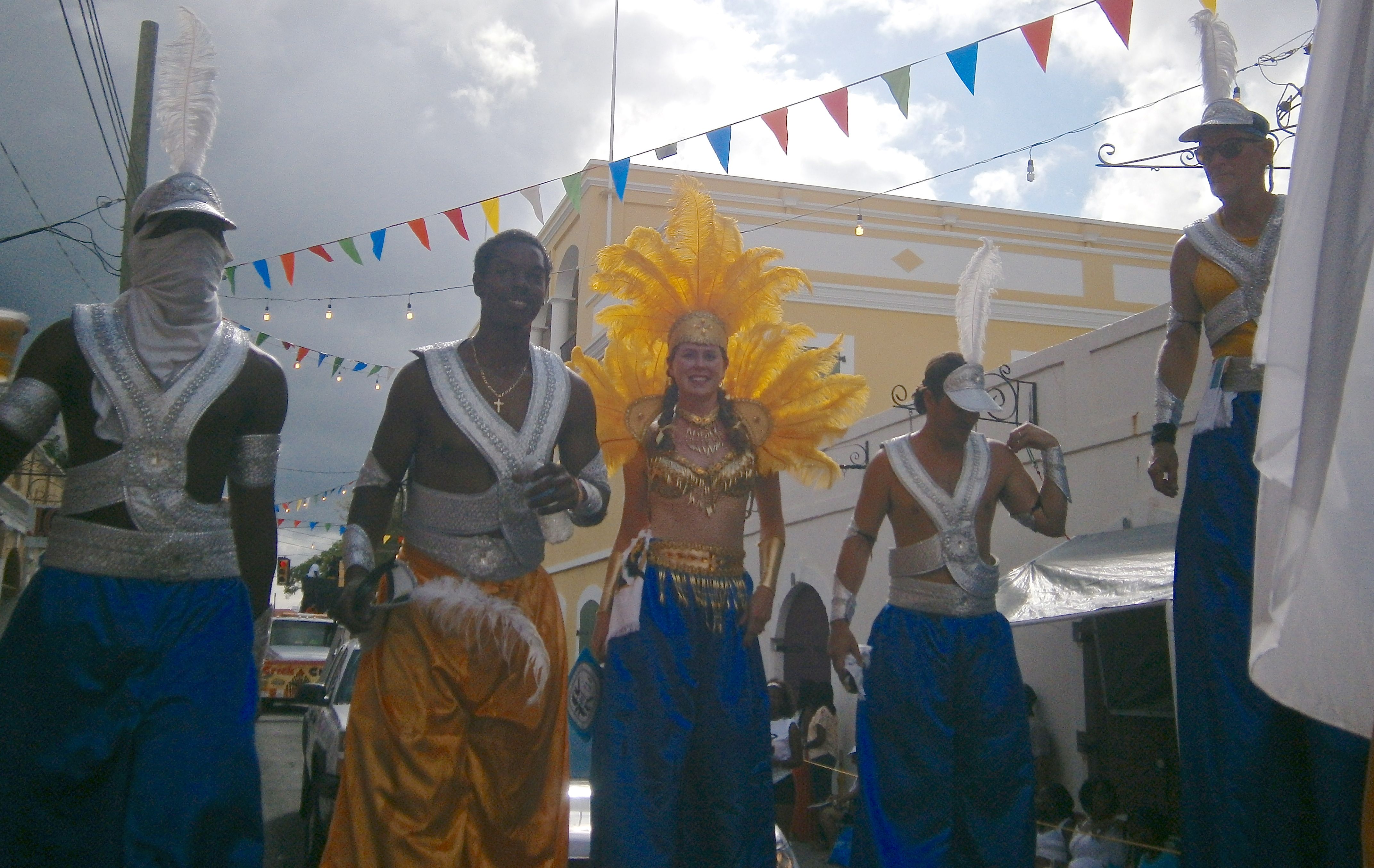 Mocko Jumbies from UVI march down the parade route.
