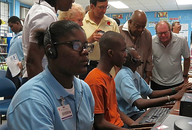 Students demonstrate the reading software to members of Rotary St. Thomas.