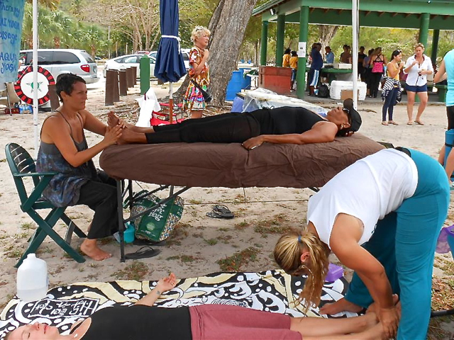 Elise McCutcheon, foreground, and Lisa Pearl-Edwards perform massages on the beach.