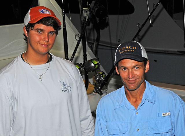 Alex Chouest, left, who at 16 years old leads the junior angler division in the Atlantic Blue Marlin Tournament, stands next his uncle and fellow angler Damon Chouest aboard the Monterey 58, Chach (Dean Barnes photo)