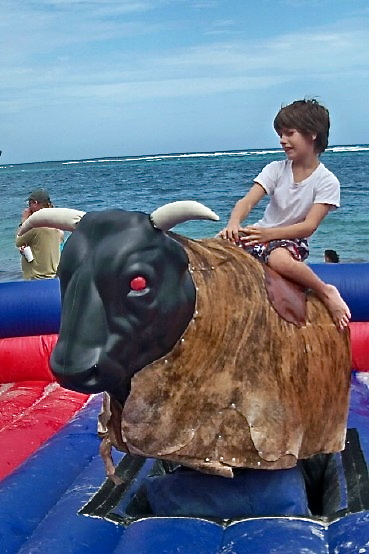 Caden Thompson, 10, takes on the mechanical bull at the United Way Chili Cookoff.