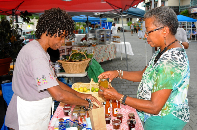 Delegate to Congress Donna Christensen, right, shops for locally-made products Saturday at the Marlin Fest’s Jump Up. (Dean Barnes photo)