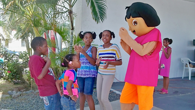 From left, Aaron Connor, Reneisha Lawrence, Pearla Lloyd and Reanna James dance with Dora the Explorer.