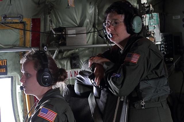 Lt. Col. Valerie Hendry watches over the shoulder of her apprentice, 2nd Lt. Leesa Froelich at the weather station.