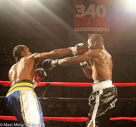 John Jackson, left, connects with Tony Hirsch during August's Boxing in Paradise V.I. tournament. (Photo © Maxi Marketing/340 Boxing)