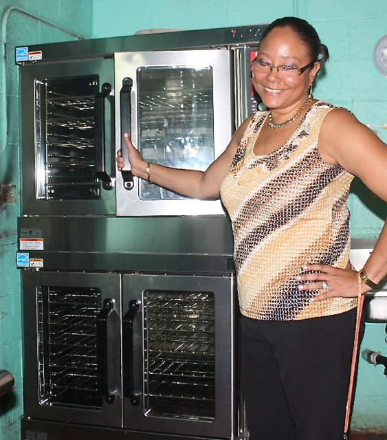Gladys Abraham Elementary Principal Lisa Hassell-Forde seems excited about her school's new oven. (Photo provided by V.I. Department of Education)