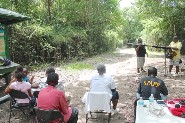 The young film team comes up with a game plan for filming a scene at the Alphonso Nelthropp Arboretum. (Jae Knight photo)