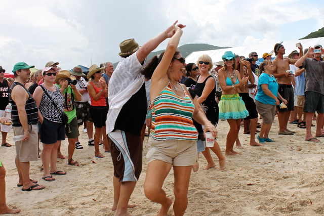 A couple dance in the sand to the live music at the chili cook-off. 