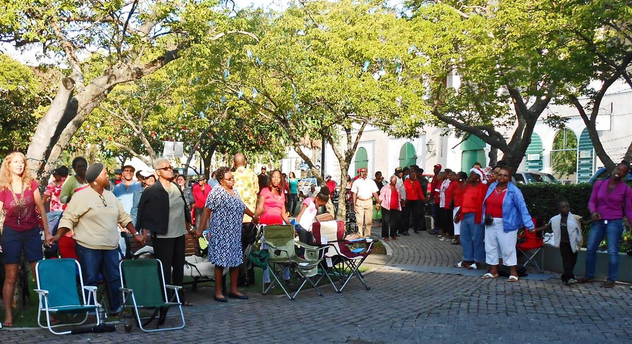 Folks gather to sing at Emancipation Garden on Christmas morning.