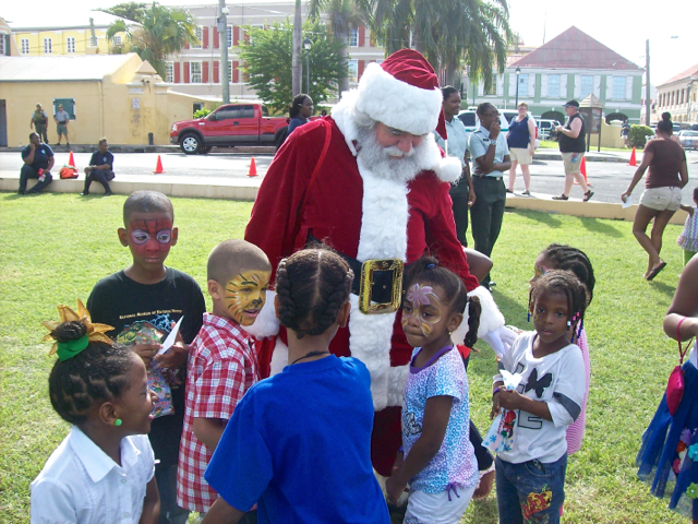 Kids greet Santa with hugs at the governor's annual Children's Holiday Party.