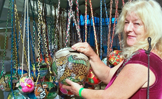 Jeanne Hughes displays purses she creates from calabash.