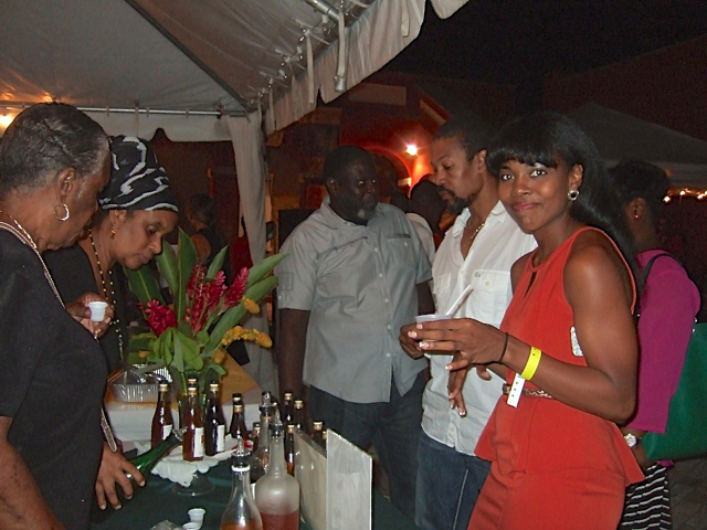 Grizelle Davila pours starfruit, sorrel, sea grape and plum wine for guests at Crucian Fusion Saturday night.