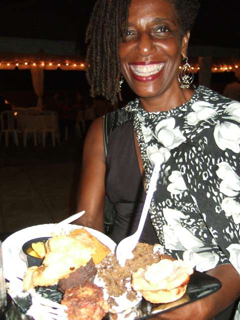 Celeste Fahie shows off a plate of food, her second, at Crucian Fusion.