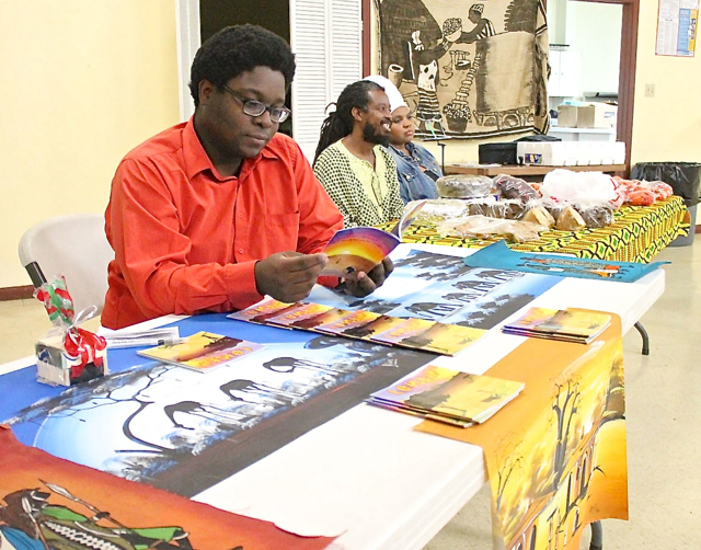 Young entrepreneur Christopher Errol Williams mans his table at the African marketplace.