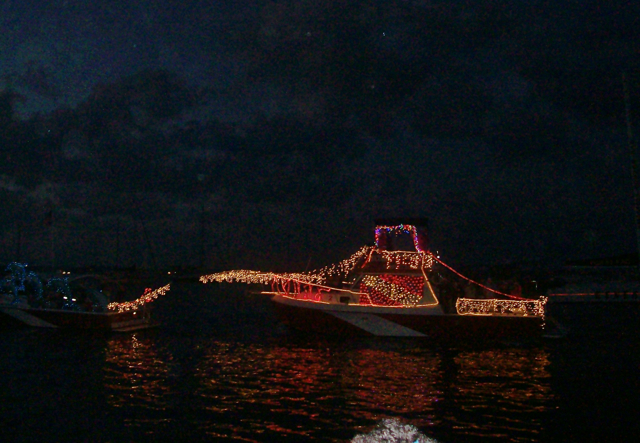 Christmas lights shimmer on the water.