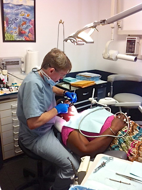 Buckley works on a patient's teeth.