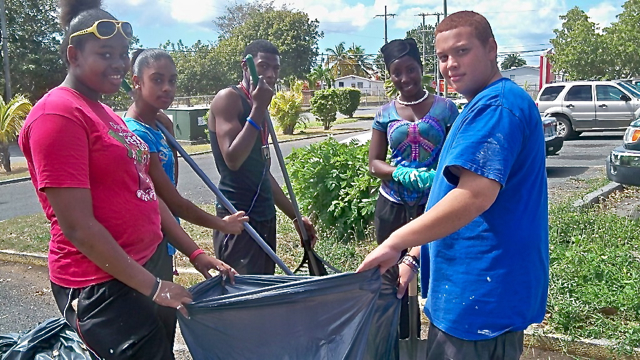 Students from Central and Complex high schools, from left, Ciyora Julius, Whitney Gooksol, Deshaun Charlemagne, Joanne Christopher and Leon Cruz work together to clean the parking lot at JFL.