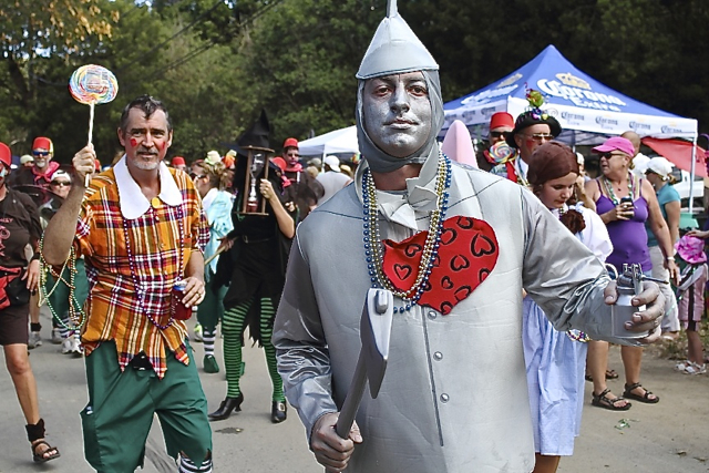 Rodrigo Fass, playing the Tin Man, leads a pack of munchkins in the Mardi Croix Parade.
