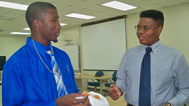 First-place winner Kendrick Campbell, left, and Chasen Richards, second place, compare experiences after they competed in the 'Four-Way Test,' Speech Contest.