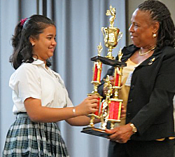 Roshni Lalwani accepts her trophy Friday from Superintendent Jeanette Smith-Barry.