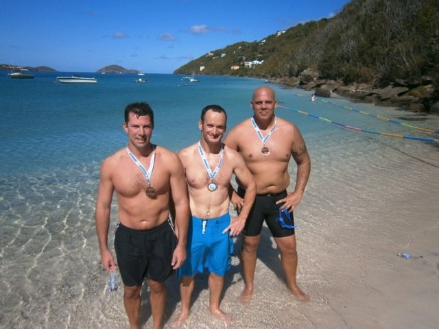 Three entrants from Team Coast Guard, from left, Todd Holm, Bryson Spangler and Rick Temperton, wear medals after the race.