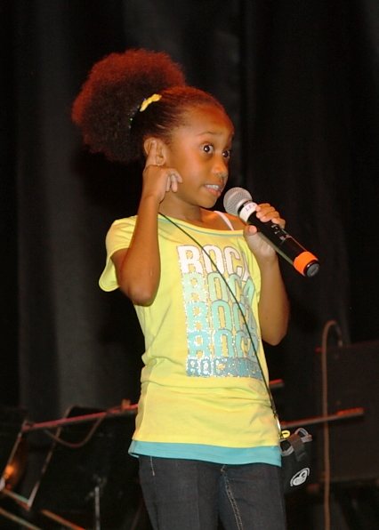 Ten-year-old junior calypso champion Janiah Christopher warms up the crowd before the competition begins.